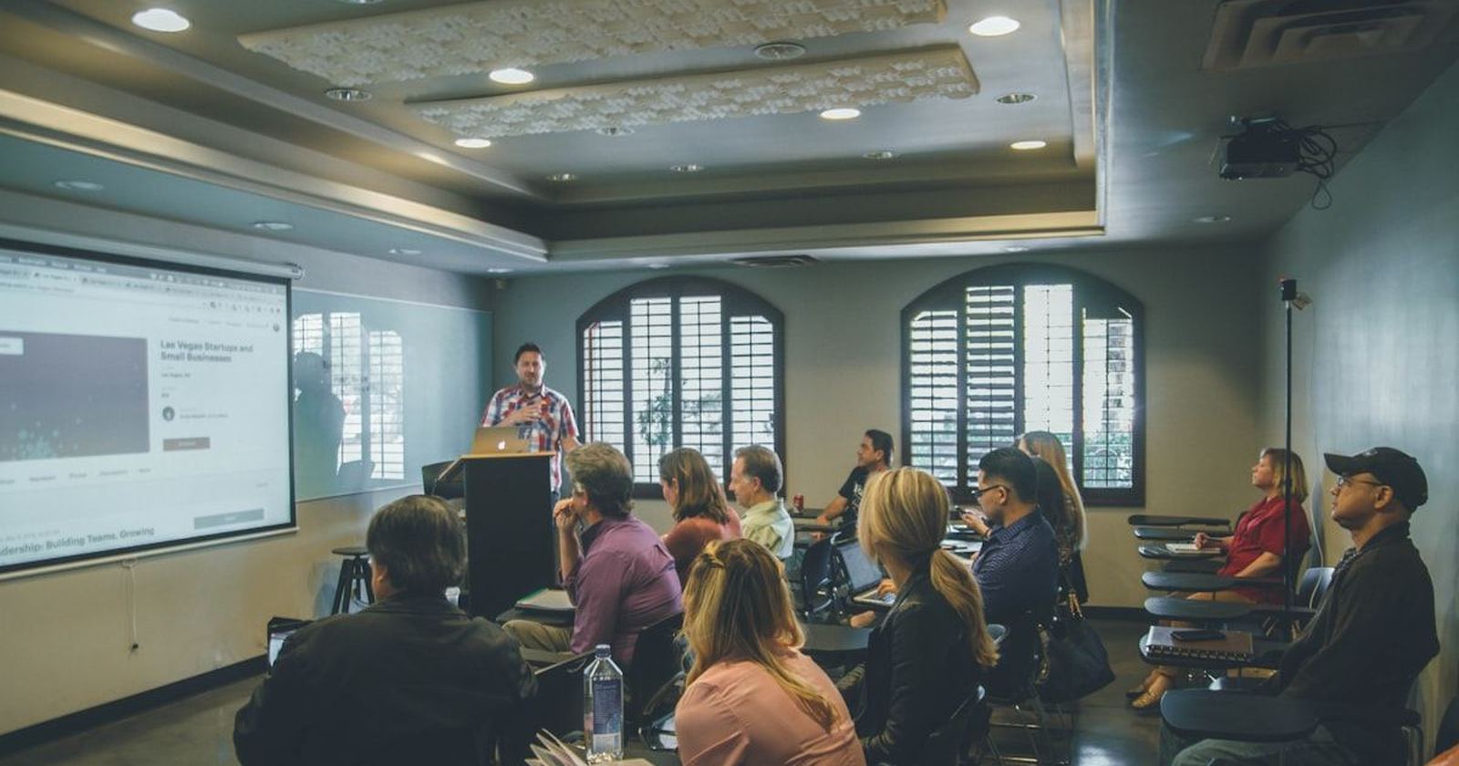 A room of seated guests listening together at a gathering
