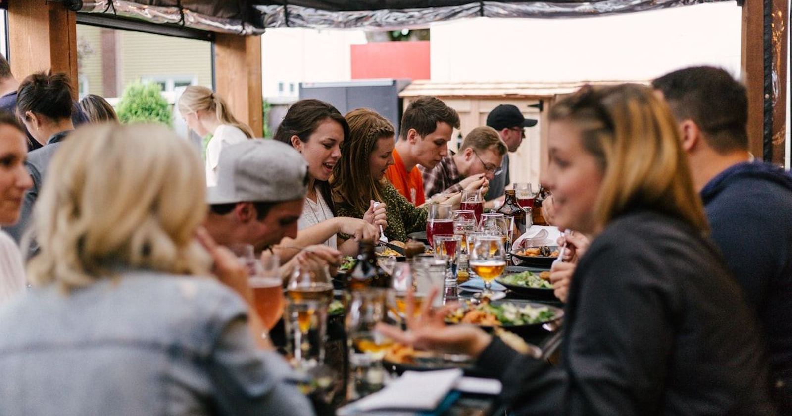 Three generations of a family eating together at one long table
